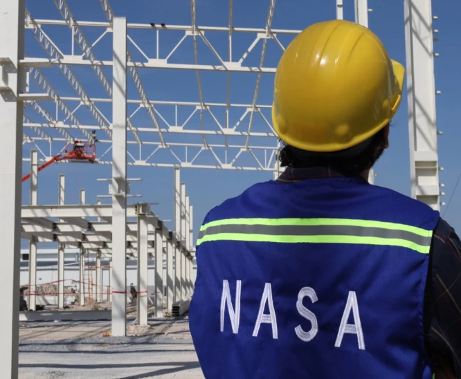 Construcutor visualizando obra con chaleco de nacional de anclas